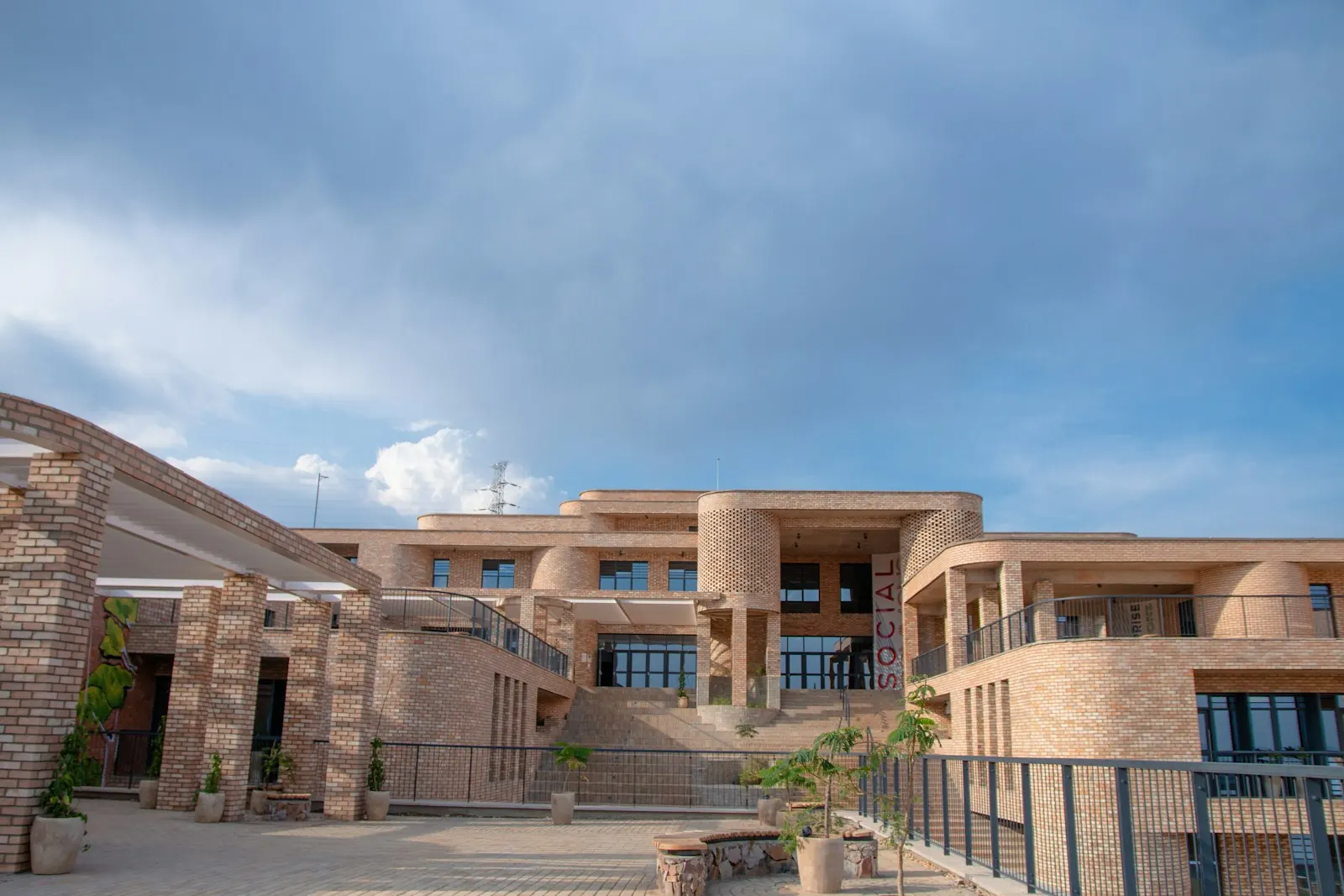 The brick buildings of a university campus in Kigali, Rwanda, under a blue sky