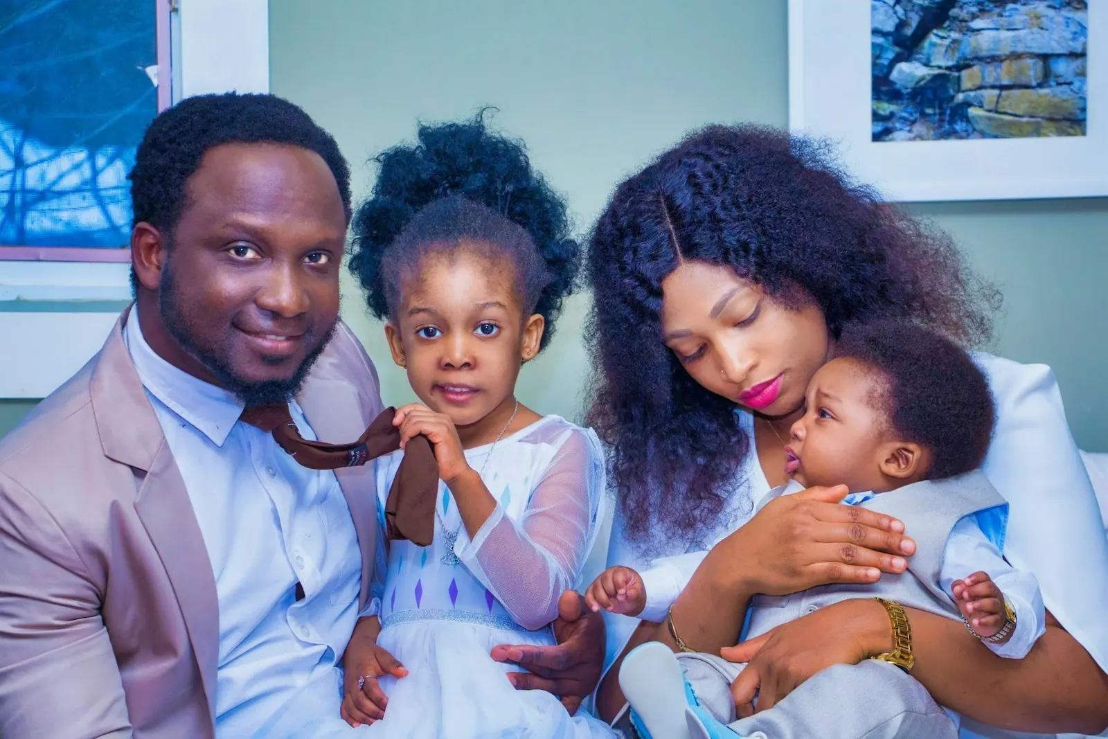 A father, a mother and their two young children together at home